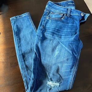 Women’s medium wash distressed skinny jeans.